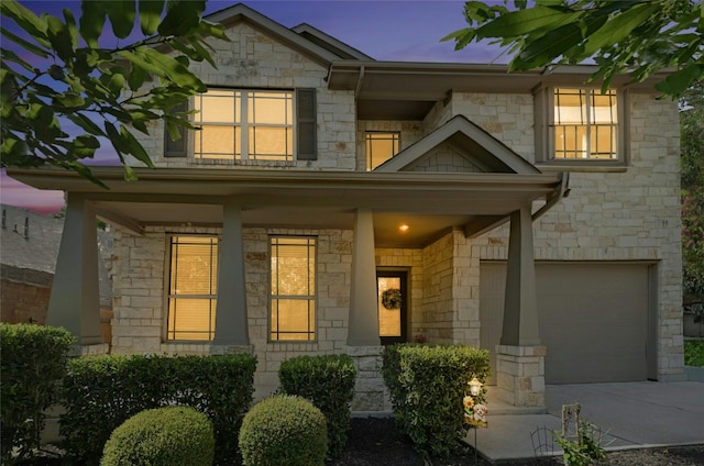 exterior entry at dusk with a garage