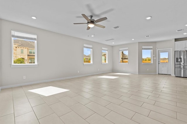 spare room with ceiling fan and light tile patterned flooring