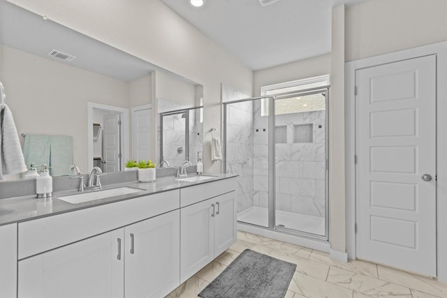 bathroom featuring vanity and a shower with shower door