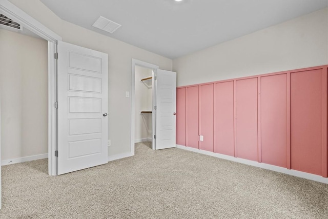 unfurnished bedroom with light carpet and a closet