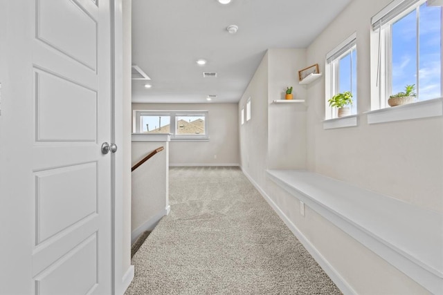 hallway with light colored carpet