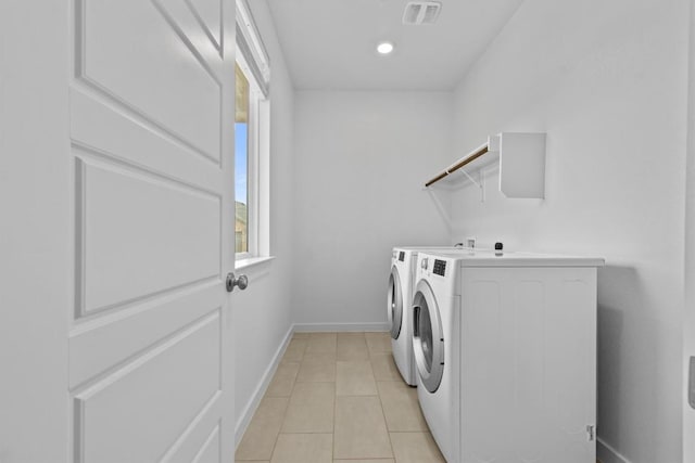 laundry area with light tile patterned floors and separate washer and dryer