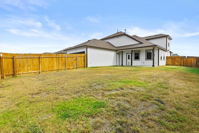 back of house with a yard