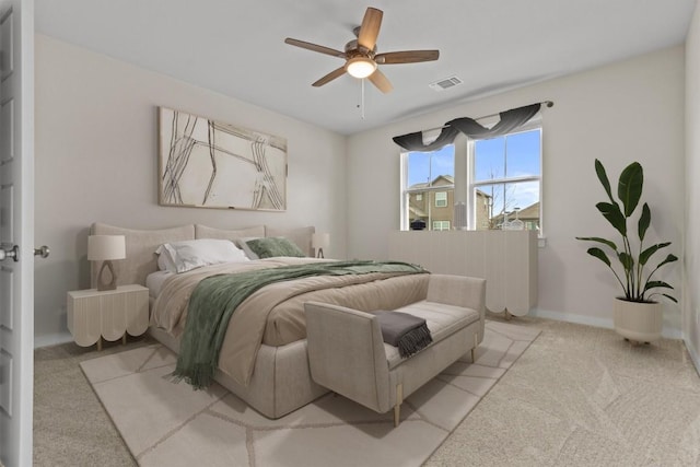 bedroom with light carpet and ceiling fan