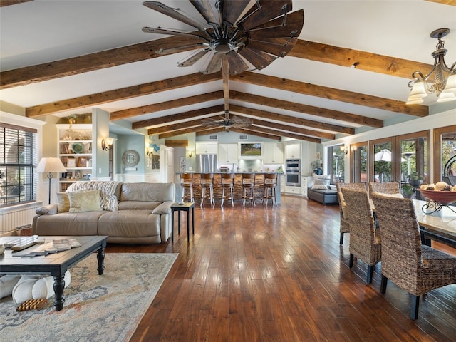 living room featuring dark hardwood / wood-style floors, lofted ceiling with beams, ceiling fan with notable chandelier, and plenty of natural light