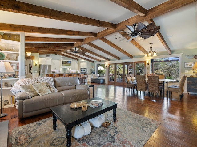 living room with a wealth of natural light, dark wood-type flooring, vaulted ceiling with beams, and ceiling fan with notable chandelier