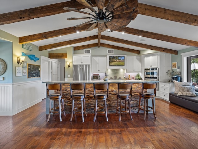 kitchen with appliances with stainless steel finishes, dark hardwood / wood-style floors, and white cabinets