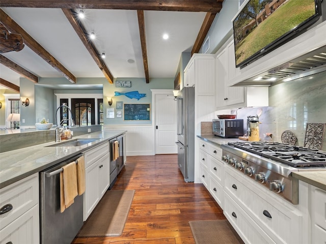 kitchen with appliances with stainless steel finishes, sink, dark hardwood / wood-style floors, and white cabinets