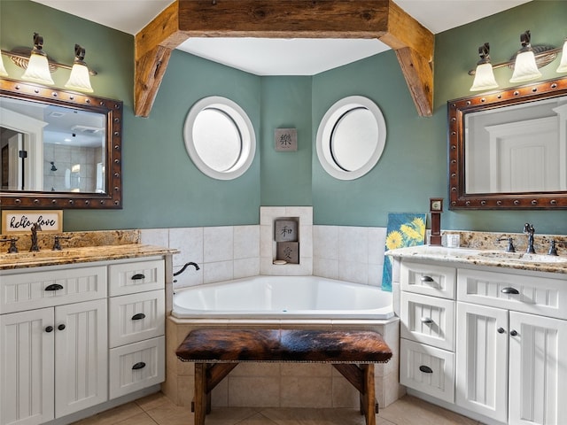 bathroom with vanity, a bath, and tile patterned flooring