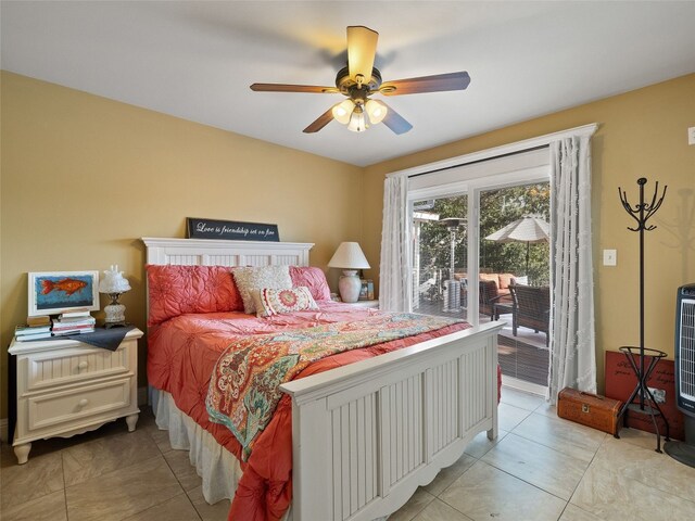 bedroom featuring access to exterior, light tile patterned floors, and ceiling fan