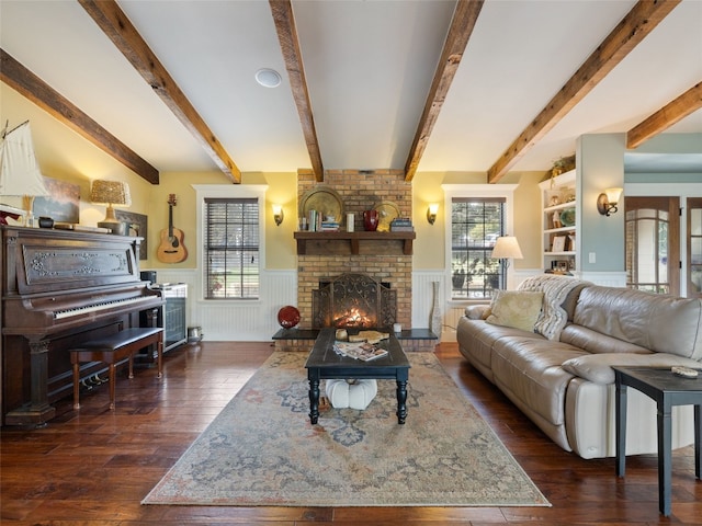 living room with beamed ceiling, a fireplace, and dark hardwood / wood-style flooring