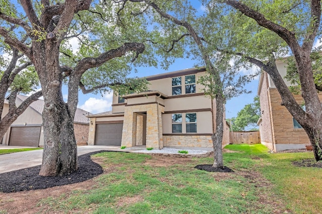 view of front of house featuring a garage and a front lawn