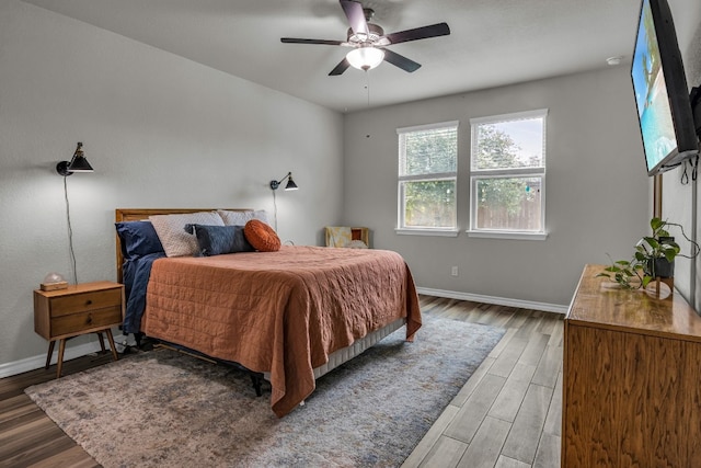 bedroom with ceiling fan and dark hardwood / wood-style floors