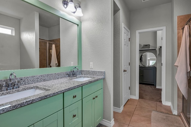 bathroom featuring tile patterned flooring, a shower, and vanity