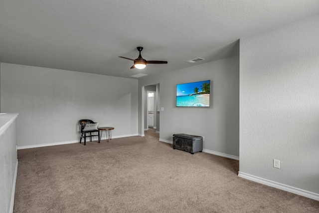 interior space with a textured ceiling and ceiling fan