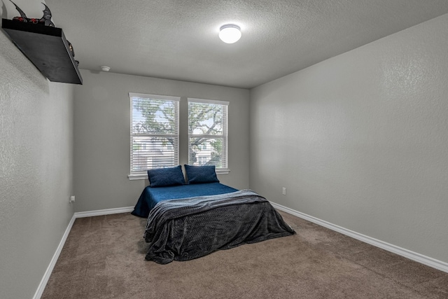 carpeted bedroom with a textured ceiling