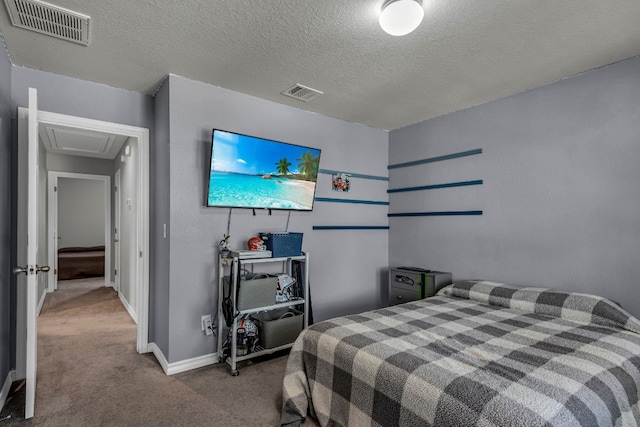 bedroom with a textured ceiling and carpet