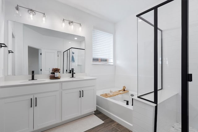 bathroom featuring vanity, independent shower and bath, and hardwood / wood-style floors