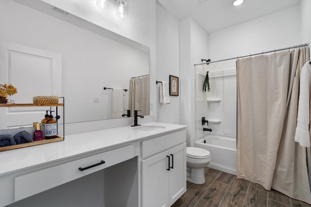 full bathroom with vanity, hardwood / wood-style floors, shower / bath combo with shower curtain, and toilet