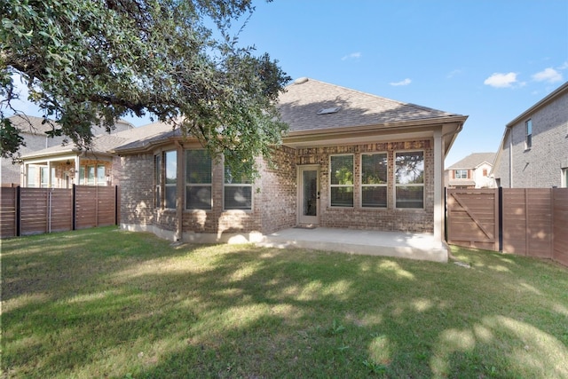 rear view of property featuring a patio and a lawn