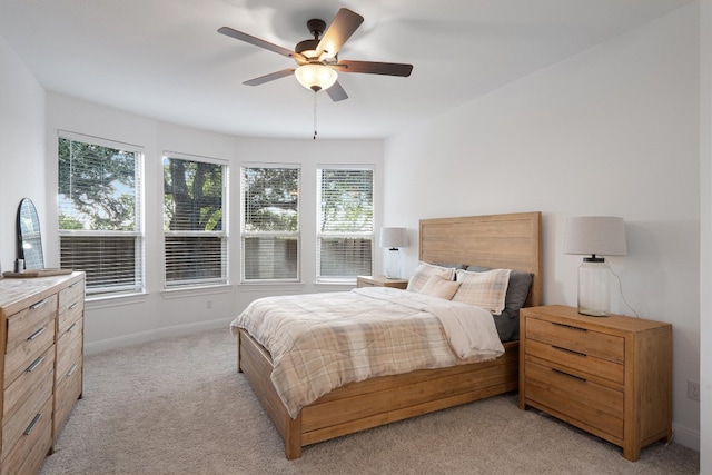 bedroom featuring ceiling fan and light carpet