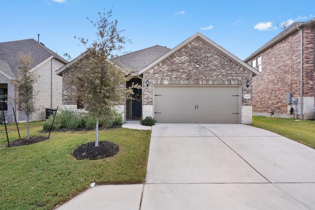 view of front of house featuring a front yard and a garage