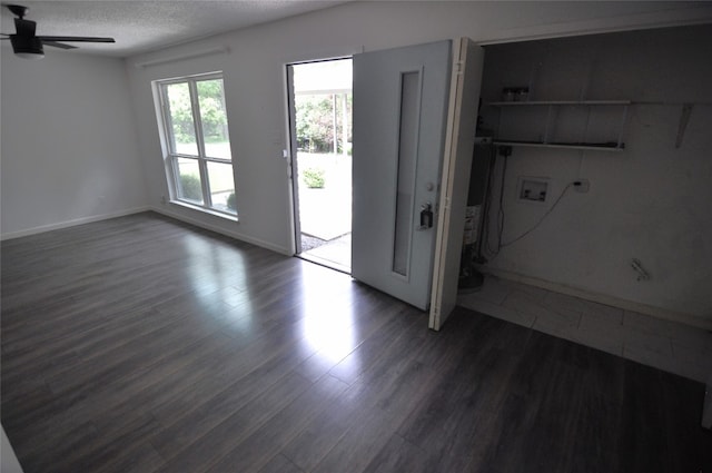 interior space with dark wood-type flooring, a textured ceiling, and ceiling fan