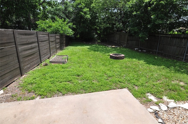 view of yard featuring an outdoor fire pit and a patio