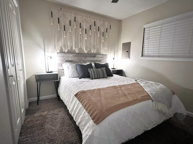 carpeted bedroom featuring a closet and ceiling fan