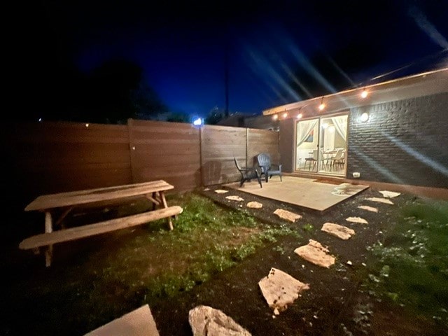 yard at twilight with a patio area