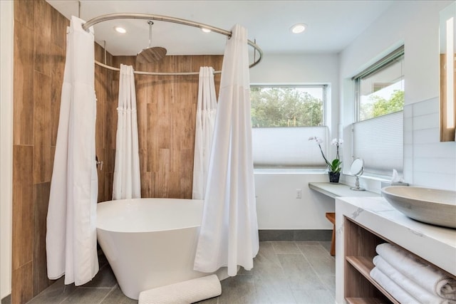 bathroom featuring tile patterned floors, vanity, and independent shower and bath