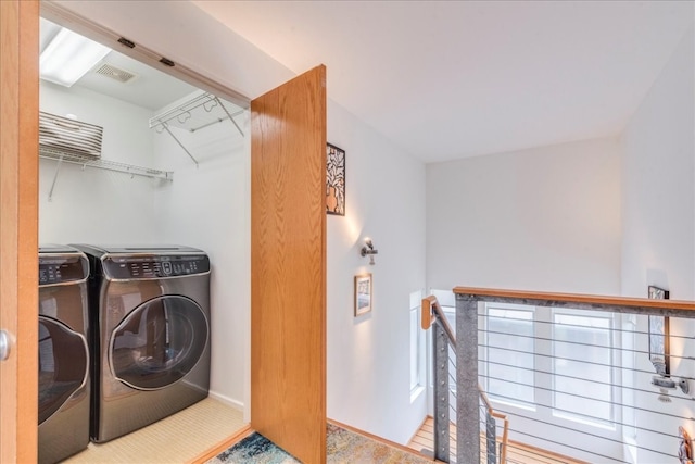 washroom with washing machine and clothes dryer