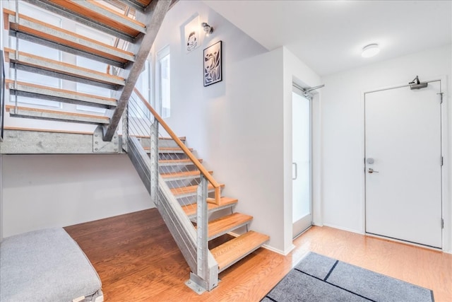 stairs with hardwood / wood-style floors