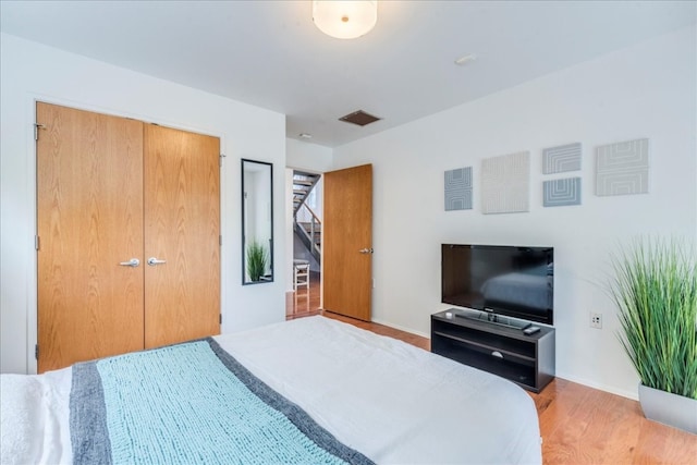 bedroom featuring a closet and light hardwood / wood-style flooring