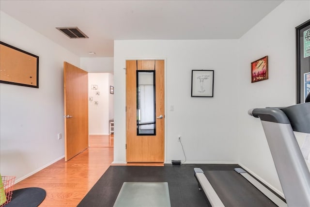 exercise area with light wood-type flooring