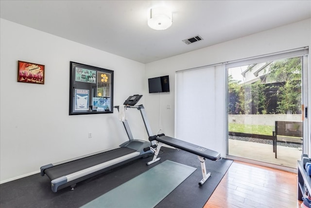 exercise room with hardwood / wood-style floors