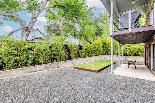 view of yard featuring ceiling fan and a patio