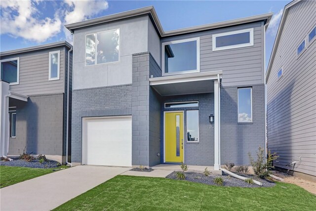 view of front facade featuring a front lawn and a garage