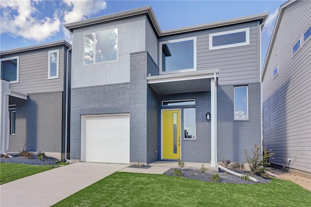 view of front of house with a garage and a front lawn