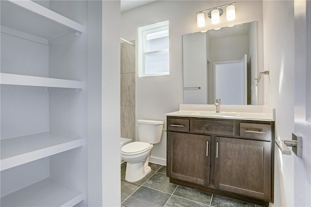 bathroom with vanity, tile patterned floors, toilet, and walk in shower