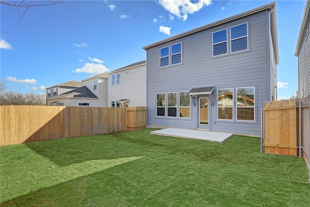 back of house featuring a patio area and a yard