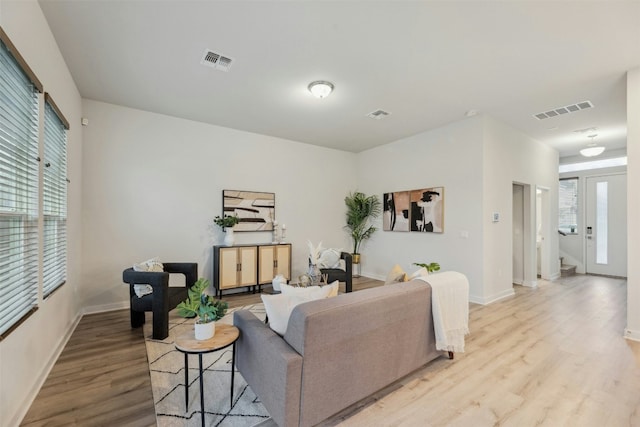 living room with light hardwood / wood-style flooring and plenty of natural light