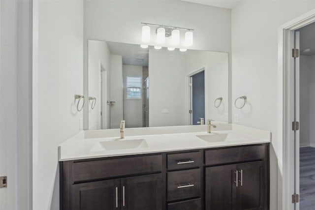 bathroom featuring vanity, hardwood / wood-style floors, and a shower with shower door