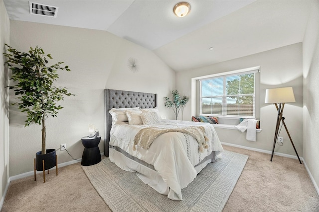 carpeted bedroom with lofted ceiling