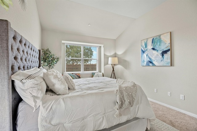 carpeted bedroom with lofted ceiling