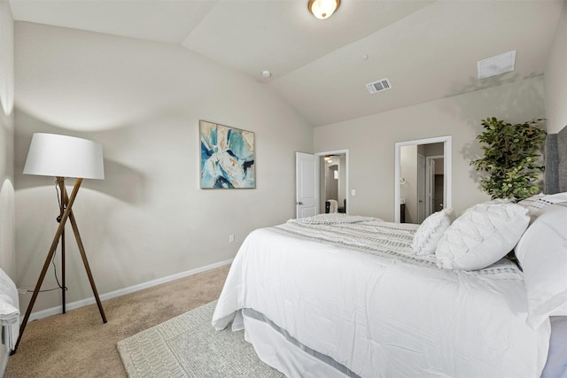 bedroom featuring baseboards, visible vents, light colored carpet, ensuite bath, and vaulted ceiling