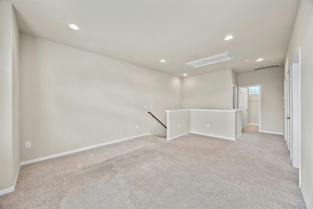 spare room featuring light carpet, recessed lighting, visible vents, and attic access