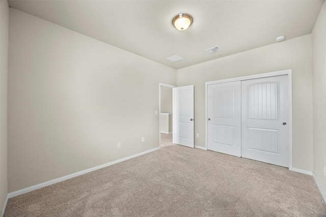 unfurnished bedroom with a closet and carpet floors