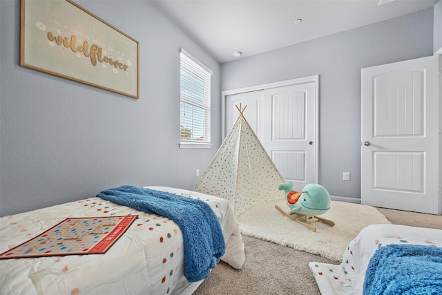 bedroom with carpet and a closet