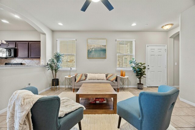 tiled living room featuring ceiling fan